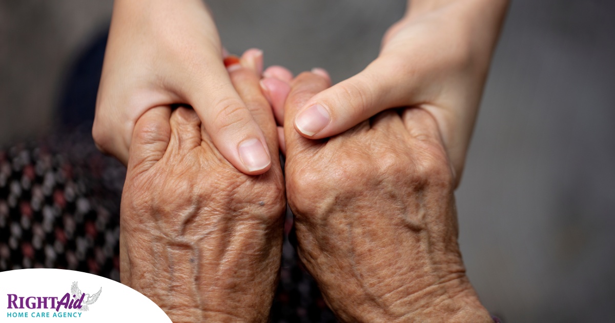 Younger hands hold older ones, representing the care and compassion of caregiving and how caregivers can help, even in ways like implementing stroke prevention strategies.