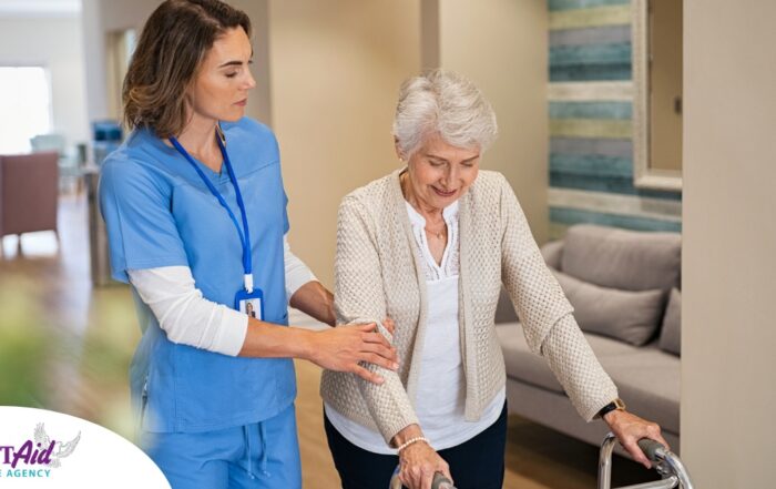 A professional caregiver helps an older client with a walker get around.