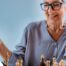 An older woman plays chess, an activity that can help older adults stay sharp.