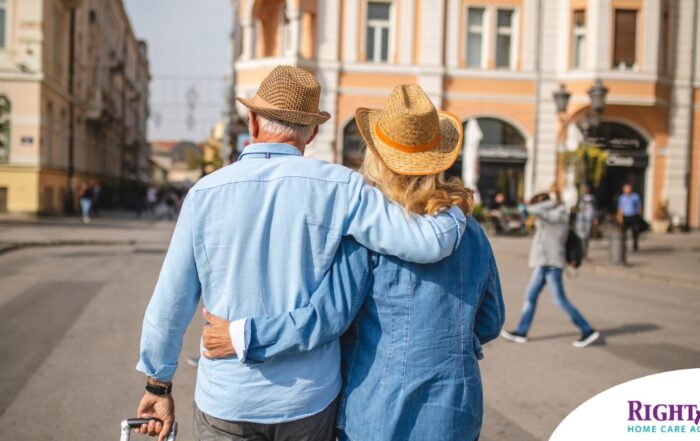 2 older adults hug while on vacation representing the successful outing that can still happen while caring for elderly loved ones.